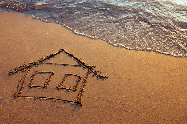 Envest Realty - Welcome, home drawn in sand